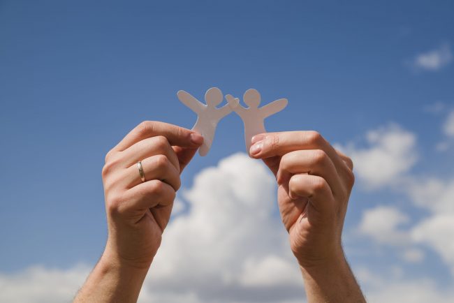 paper-dolls-against-sky